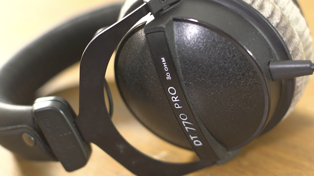This is a close up image of the DT770 80OHM Headphones. They are black with white ear protectors.