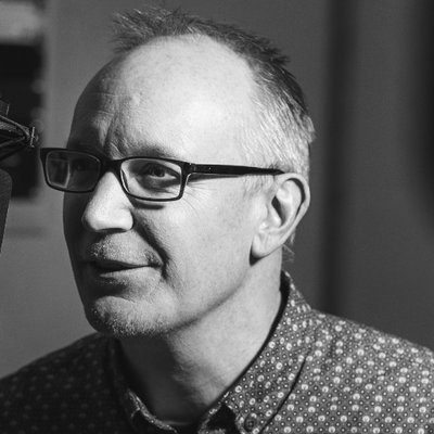 Image shows a black and white headshot of David LLoyd.